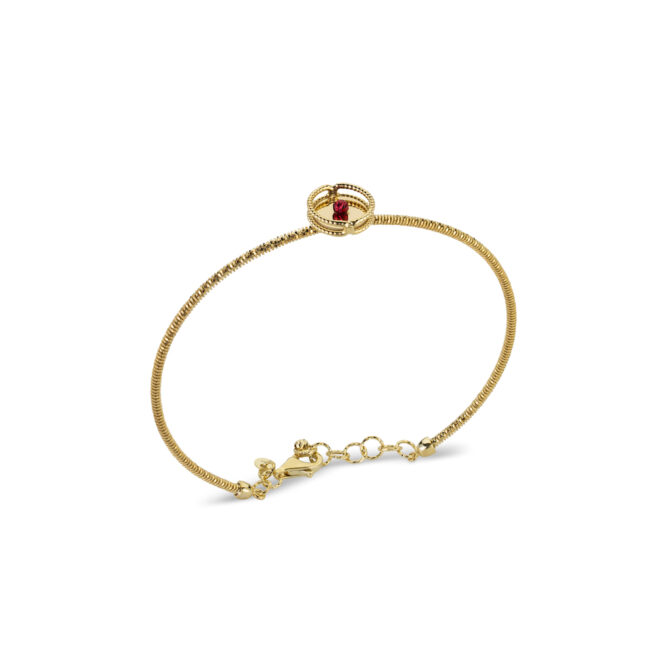 Gold bangle with gold coloured element